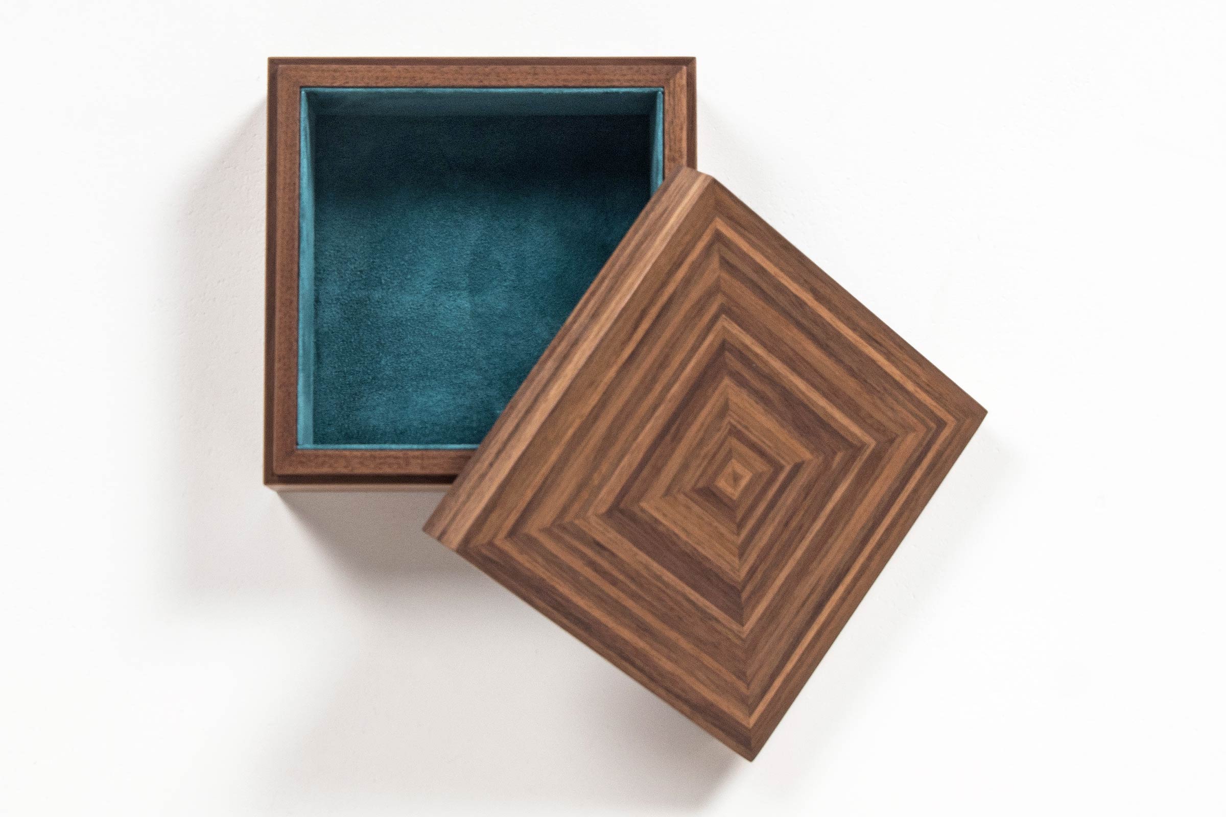 Linear Murano trinket box made in walnut with teal suede lining Linear Murano trinket box made in walnut with teal suede lining top view with lid lifted off